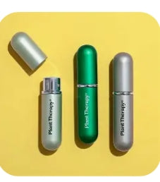 Three small cylindrical containers with labels on a yellow background