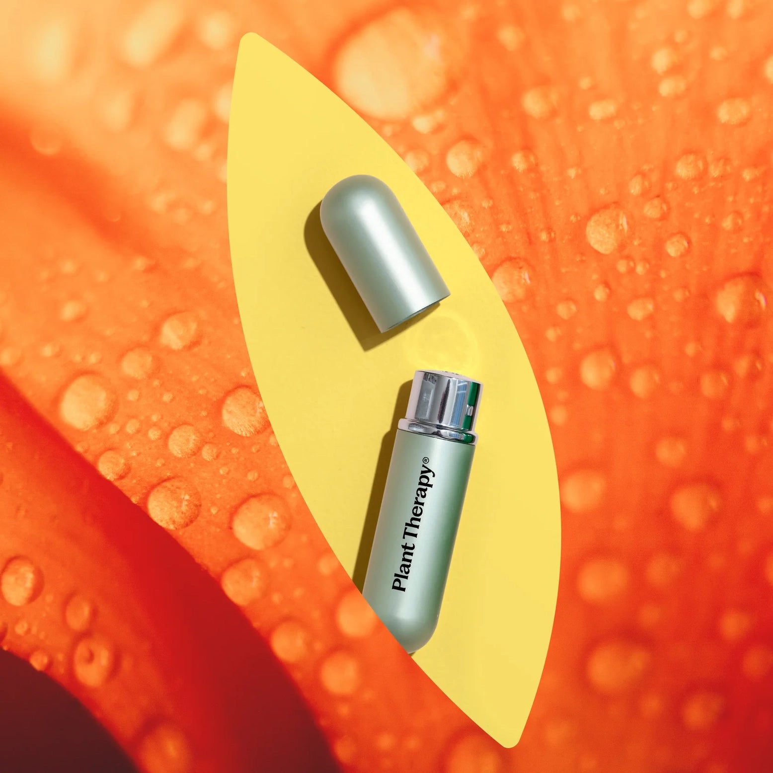 One open inhaler labeled 'Plant Therapy' on a yellow leaf with an orange background