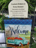 Custom order sign with small welcome flag in a black flag stand