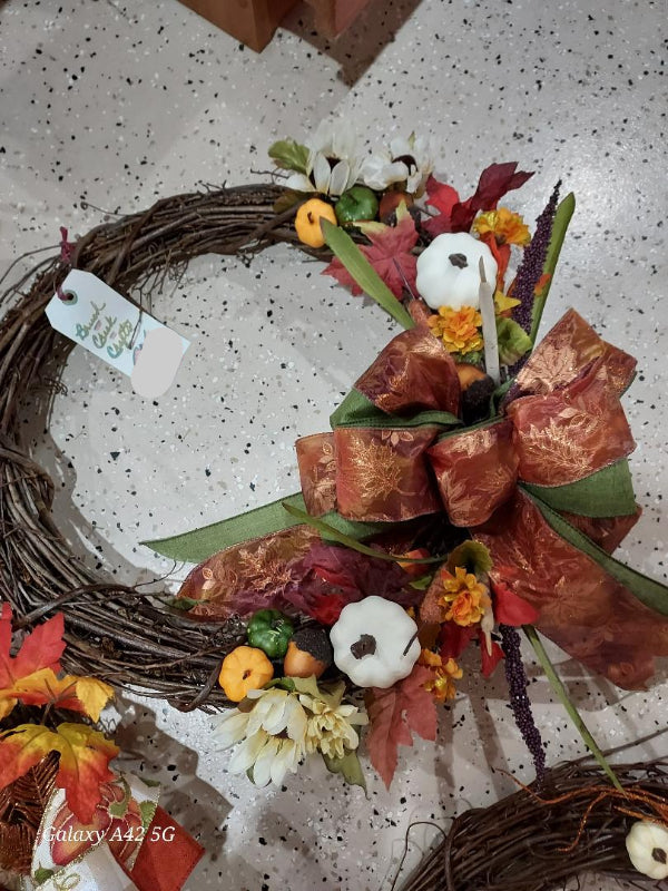 Decorative wreath with autumnal elements on a speckled surface