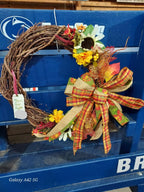 Decorative wreath with a bow on a blue surface