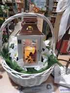 Decorative basket with a lantern and floral arrangement in a store setting